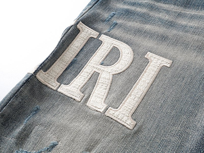 AMIRI Light Blue Distressed Letter Applique Jeans — detail